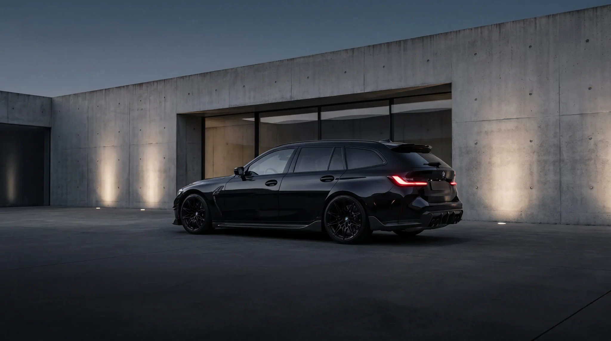 Black BMW M3 Touring outside a modern concrete building